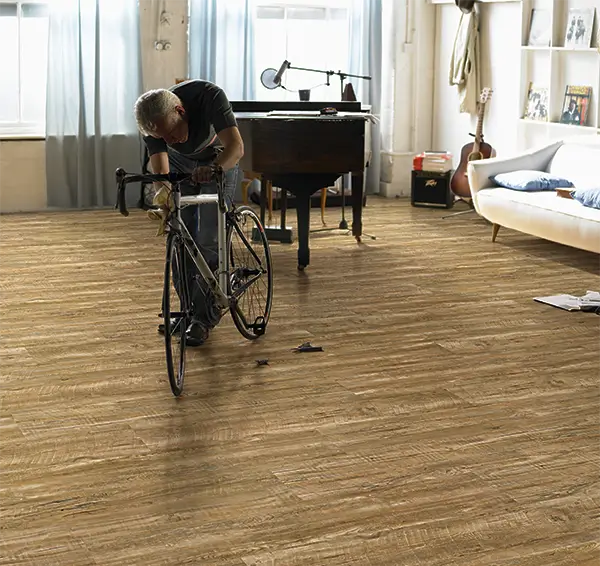 Guy with a bike on hard wood flooring