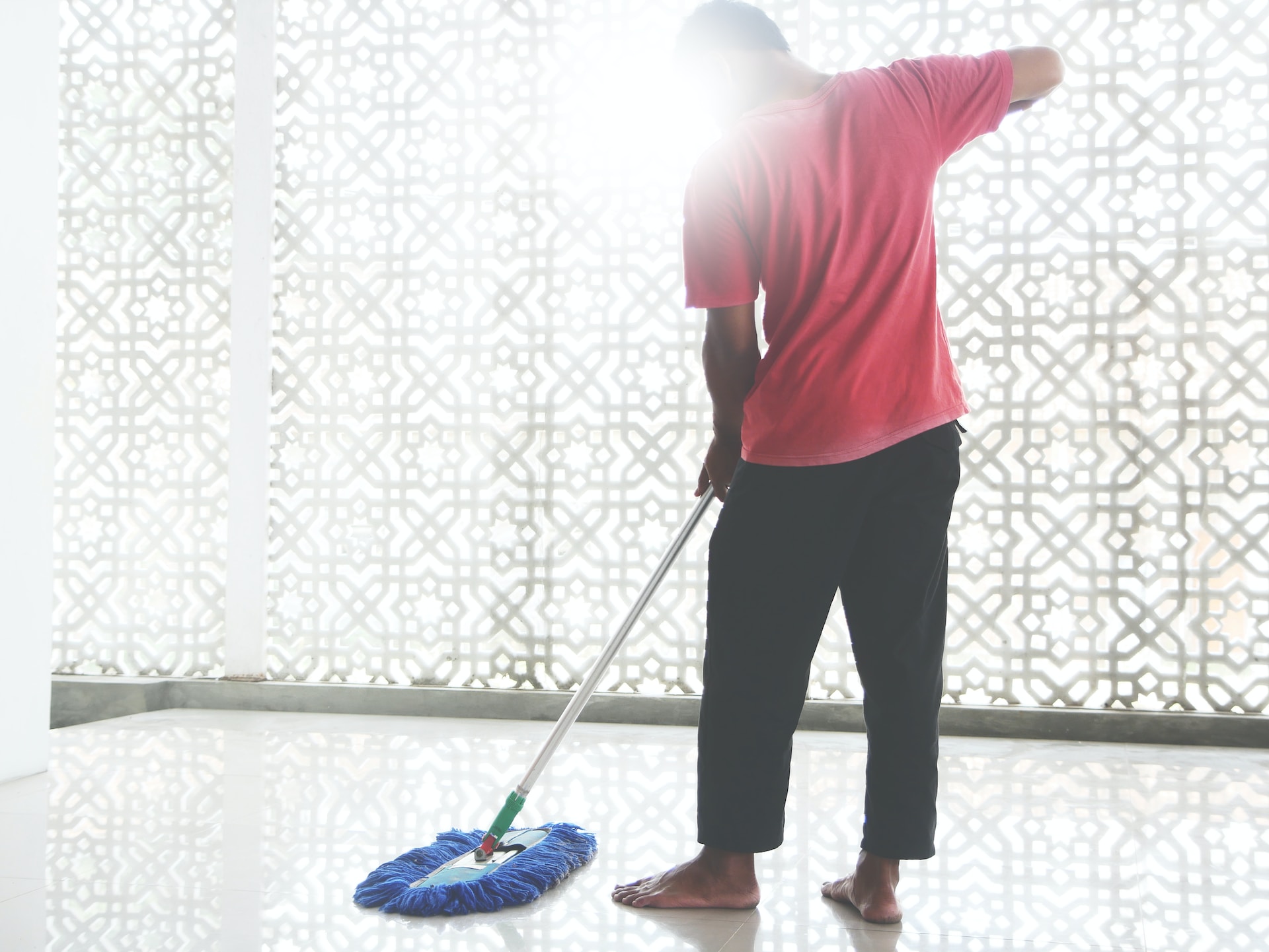 A Dallas, TX homeowner cleaning and maintaining their new tile flooring