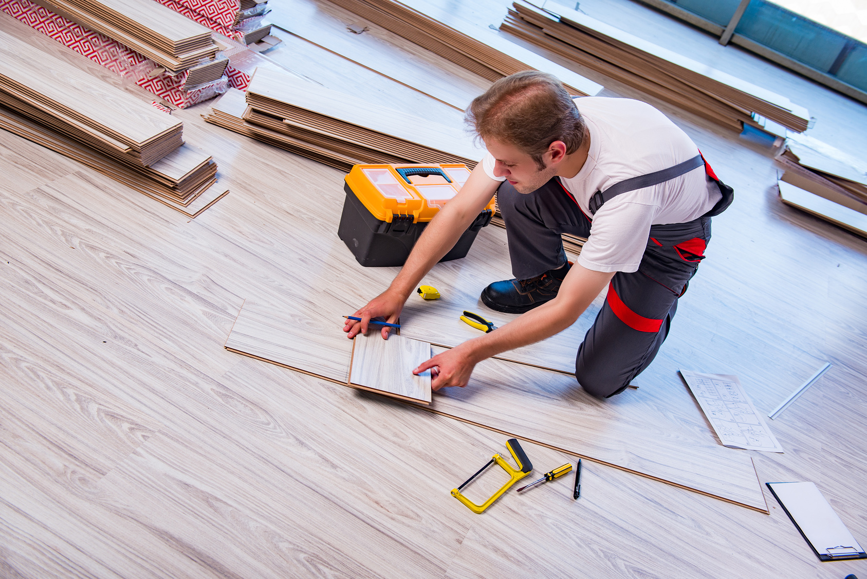 man measuring tile