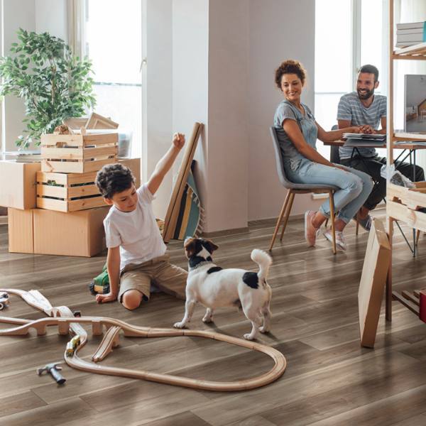 Kids playing with a dog on flooring