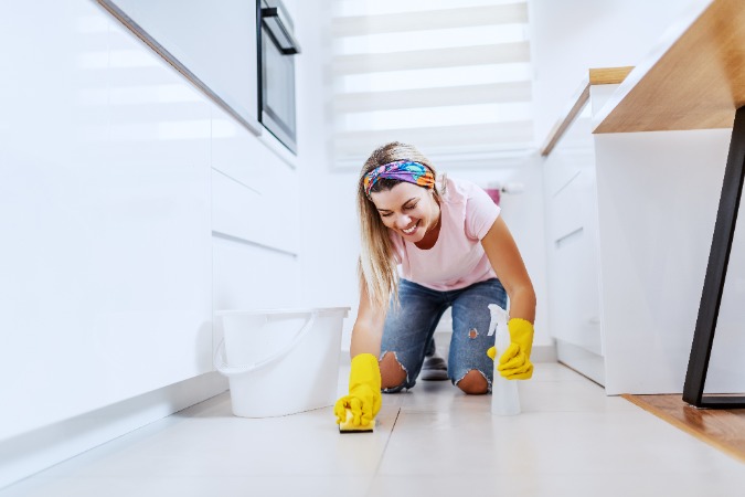 woman cleaning tile floor